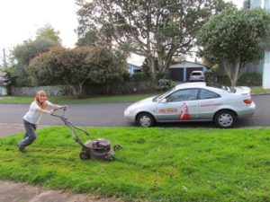 Cr Cathy Casey gets to work mowing her berm